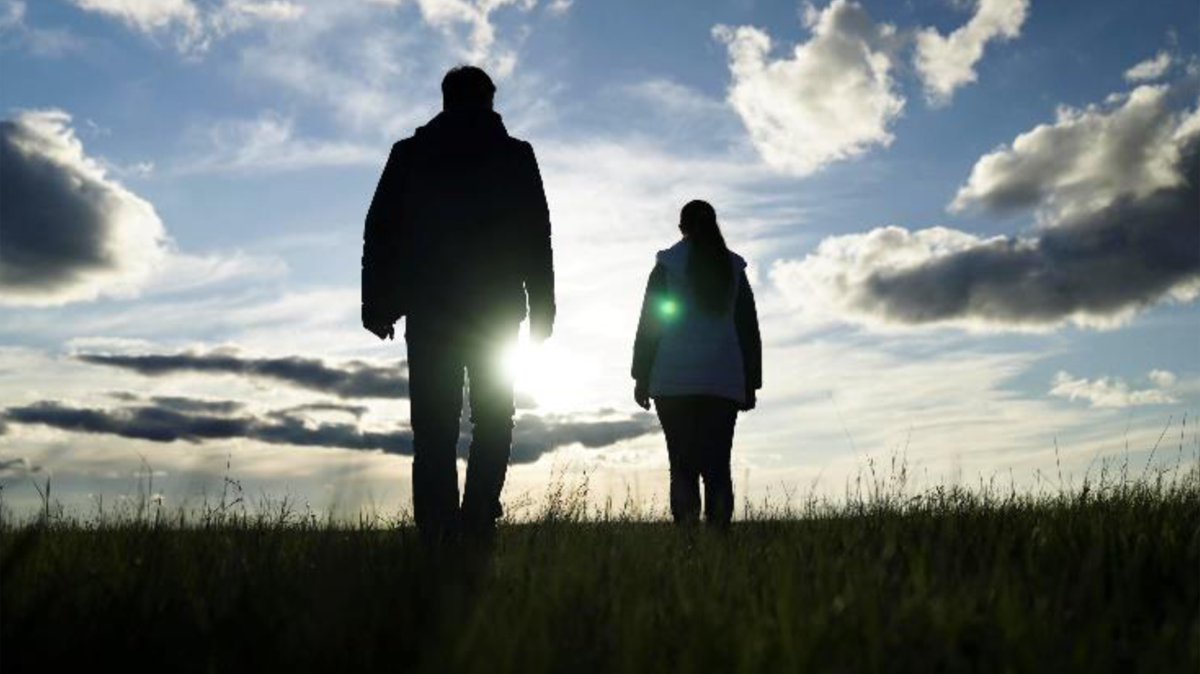 Figure&nbsp;2 &ndash; Man and woman walking towards the sunset.